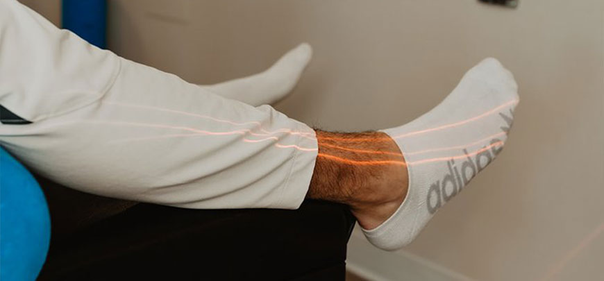 patient receiving class iv laser therapy as part of her neuropathy treatment protocol